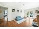 Bright living room featuring hardwood floors, paneled walls, and access to the patio at 1423 Fairfield Ave, Charleston, SC 29407