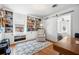 This office features built-in bookshelves, hardwood floors, and a sliding barn door at 1423 Fairfield Ave, Charleston, SC 29407