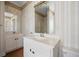 Bathroom featuring double vanity sinks, decorative wallpaper and tiled flooring at 144 St Phillips Row, Summerville, SC 29485