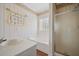 Relaxing bathroom with tub, shower, and striped wallpaper at 144 St Phillips Row, Summerville, SC 29485