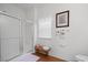 Bright bathroom featuring glass-enclosed shower, wood floors, a window, and neutral decor at 144 St Phillips Row, Summerville, SC 29485