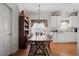 Cozy dining area features a rustic wooden table, hardwood floors, and ample natural light from the window at 144 St Phillips Row, Summerville, SC 29485