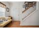 Inviting entryway featuring a cozy sitting area, staircase, and decorative wall art at 144 St Phillips Row, Summerville, SC 29485