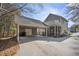 Two-story home featuring an attached carport, screened porch, and upper-level balcony at 144 St Phillips Row, Summerville, SC 29485