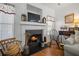 The living room fireplace is framed by windows and features an ornate mantel at 144 St Phillips Row, Summerville, SC 29485