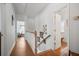 Bright hallway with wood floors and staircase leads to bedrooms and bathrooms upstairs at 144 St Phillips Row, Summerville, SC 29485