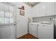 Functional laundry room featuring white cabinets and modern washer and dryer at 144 St Phillips Row, Summerville, SC 29485