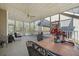 Relaxing screened porch with comfortable seating, tile table, and views of the wooded backyard at 144 St Phillips Row, Summerville, SC 29485