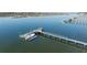 A scenic aerial view of a private dock extending into calm waters, complete with a boat and serene surroundings at 1464 Dupree Creek Rd, Awendaw, SC 29429