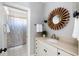 Bathroom featuring a granite countertop, decorative mirror, and a shower with blue floral pattern at 1464 Dupree Creek Rd, Awendaw, SC 29429