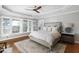 Bedroom featuring a tray ceiling, hardwood floors, and a waterfront view at 1464 Dupree Creek Rd, Awendaw, SC 29429