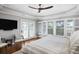 Bedroom featuring a tray ceiling, hardwood floors, water views, and outdoor access at 1464 Dupree Creek Rd, Awendaw, SC 29429