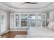 Bedroom featuring a tray ceiling, hardwood floors, and scenic water views at 1464 Dupree Creek Rd, Awendaw, SC 29429