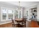 Bright dining area features hardwood floors, modern chandelier, and abundant natural light at 1464 Dupree Creek Rd, Awendaw, SC 29429