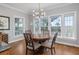 Charming dining room with hardwood floors, chandelier, and scenic backyard views at 1464 Dupree Creek Rd, Awendaw, SC 29429