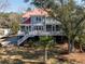 Inviting exterior with a spacious deck, perfect for enjoying waterfront living and outdoor entertaining at 1464 Dupree Creek Rd, Awendaw, SC 29429