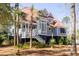 Charming two-story home featuring a red roof, gray siding, elevated structure, and a welcoming white staircase at 1464 Dupree Creek Rd, Awendaw, SC 29429