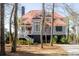 Charming two-story home featuring a red roof, gray siding, elevated structure, and a welcoming white staircase at 1464 Dupree Creek Rd, Awendaw, SC 29429