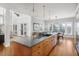 Open concept kitchen with large island, granite countertops, and adjacent dining area at 1464 Dupree Creek Rd, Awendaw, SC 29429