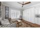 Sitting room featuring a zebra-print couch, wooden floors, and built-in shelves at 1464 Dupree Creek Rd, Awendaw, SC 29429
