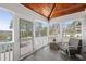 Relaxing porch area with wood-look tile flooring, ceiling fan, and outdoor view at 1464 Dupree Creek Rd, Awendaw, SC 29429