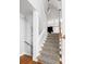 Staircase featuring leopard print carpet, white risers, and a wooden handrail at 1464 Dupree Creek Rd, Awendaw, SC 29429