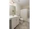 Well-lit bathroom featuring a shower over the bath, toilet, sink and storage cabinets at 1516 Oldenburg Dr, Mount Pleasant, SC 29466