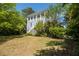 Charming home boasts a spacious porch, blending seamlessly with its lush, verdant surroundings at 1543 Wando Landing St, Charleston, SC 29492