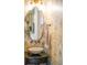 Stylish powder room boasts elegant wallpaper, a vessel sink, and designer fixtures at 1543 Wando Landing St, Charleston, SC 29492