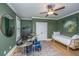 This bedroom features olive green walls, hardwood floors, vintage furniture, a ceiling fan and a day bed at 1543 Wando Landing St, Charleston, SC 29492