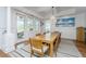 Dining room with a large chandelier, view to the outside patio, natural lighting, and a jute rug at 1543 Wando Landing St, Charleston, SC 29492