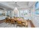 Bright dining room features a wooden table, chandelier, and windows for natural light at 1543 Wando Landing St, Charleston, SC 29492