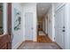 Bright and airy entryway with hardwood floors, white trim, and a glimpse into a hallway at 1543 Wando Landing St, Charleston, SC 29492