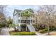 Charming two-story home featuring double porches, lush landscaping, and a grand entrance staircase at 1543 Wando Landing St, Charleston, SC 29492