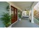 Inviting covered front porch with a swing, ceiling fan, and views of the surrounding landscape at 1543 Wando Landing St, Charleston, SC 29492