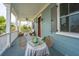 Outdoor porch with dining table, ceiling fan, columns, palm trees, and wicker couches for inviting ambiance at 1543 Wando Landing St, Charleston, SC 29492