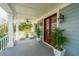 Welcoming front porch featuring outdoor seating, ceiling fans, and stylish decor at 1543 Wando Landing St, Charleston, SC 29492