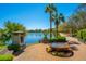 Relaxing lakefront spot with a decorative water feature, lush greenery, and walking path on a clear, sunny day at 1543 Wando Landing St, Charleston, SC 29492