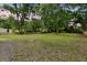 Expansive backyard with trees and a wooden fence, offering plenty of room for recreation at 1563 Traywick Ave, Johns Island, SC 29455