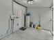Spacious basement area with painted floor, water heater, shelving, and access door at 1563 Traywick Ave, Johns Island, SC 29455