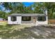 Charming single-story home with a well-manicured lawn, black shutters, and a freshly painted exterior at 1563 Traywick Ave, Johns Island, SC 29455