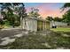 Rear exterior view of home and screen patio at dusk at 1563 Traywick Ave, Johns Island, SC 29455