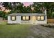 Charming single-story home with a well-manicured lawn, black shutters, and a freshly painted exterior at 1563 Traywick Ave, Johns Island, SC 29455