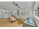 Bright living room with modern lighting, decor, and an open floor plan to the dining area at 1563 Traywick Ave, Johns Island, SC 29455