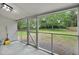 View of screened-in patio with view to landscaped backyard with mature trees at 1563 Traywick Ave, Johns Island, SC 29455