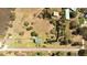 Aerial view of a spacious property with a pond, sheds, and a well-maintained lawn at 16 Baldwin Ln, Green Pond, SC 29446
