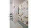 Close-up on a shower with a seashell themed shower curtain, a magazine rack, and a towel at 16 Baldwin Ln, Green Pond, SC 29446