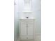 Classic bathroom vanity in white with a small shelf and wall mirror in a room with calming painted walls at 16 Baldwin Ln, Green Pond, SC 29446