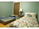 Cozy bedroom with a floral-patterned single bed, window, side table, and dog bed at 16 Baldwin Ln, Green Pond, SC 29446