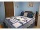 Comfortable bedroom with a large bed, nautical quilt, and plenty of natural light from the window at 16 Baldwin Ln, Green Pond, SC 29446